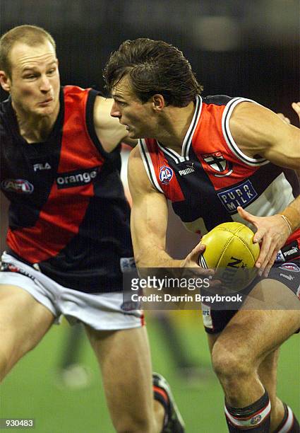 Aaron Hamill#2 for St.Kilda runs past Sean Wellman for Essendon during the round 11 AFL match between the St.Kilda Saints and the Essendon Bombers,...