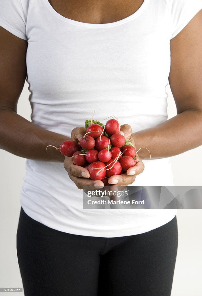 Woman holding radishes