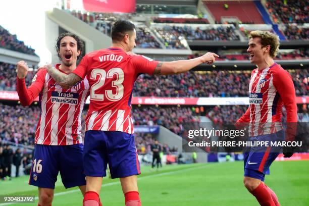 Atletico Madrid's Spanish forward Vitolo celebrates with Atletico Madrid's French forward Antoine Griezmann and Atletico Madrid's Croatian defender...