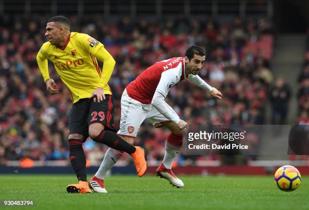 Henrikh Mkhitaryan of Arsenal takes on Etienne Capoue of Watford during the Premier League match between Arsenal and Watford at Emirates Stadium on...