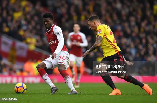Ainsley Maitland-Niles of Arsenal is challenged by Jose Holebas of Watford during the Premier League match between Arsenal and Watford at Emirates...