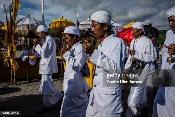 Hindus devotees pray during the Melasti ritual ceremony at Parangkusumo beach on March 11, 2018 in Yogyakarta, Indonesia.The Melasti ritual is held...