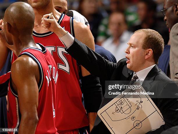 Head coach Lawrence Frank of the New Jersey Nets reacts holding his whiteboard after a time out during the game against the Orlando Magic on November...
