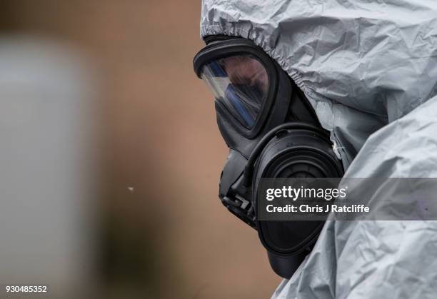 Military personnel wearing protective suits remove a police car and other vehicles from a public car park as they continue investigations into the...