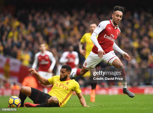 Pierre-Emerick Aubameyang of Arsenal is challenged by Adrian Mariappa of Watford during the Premier League match between Arsenal and Watford at...