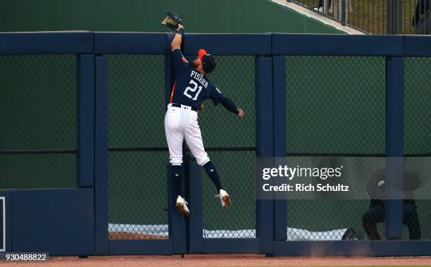 Left fielder Derek Fisher of the Houston Astros attempts to make a catch on a home hit by Paul DeJong of the St. Louis Cardinals during the second...