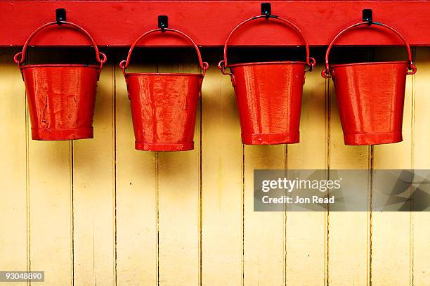 four red buckets. - bucket stock pictures, royalty-free photos & images