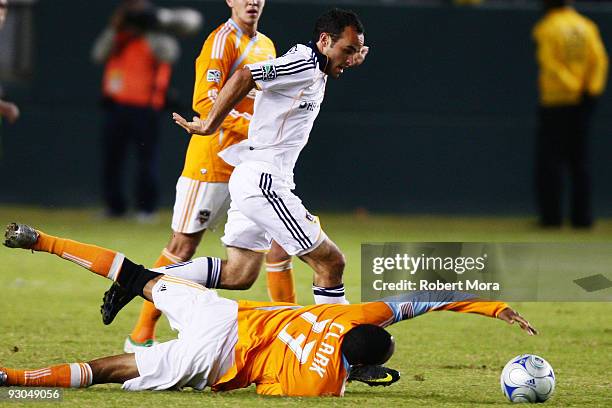 Landon Donovan of the Los Angeles Galaxy attacks the defense of Ricardo Clark of the Houston Dynamo during their MLS Western Conference Championship...