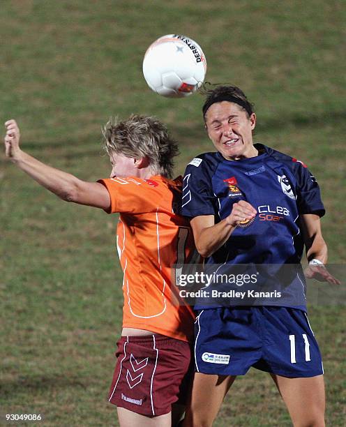 Julianne Sitch of the Victory and Courtney Beutel of the Roar compete for the ball during the round seven W-League match between the Queensland Roar...