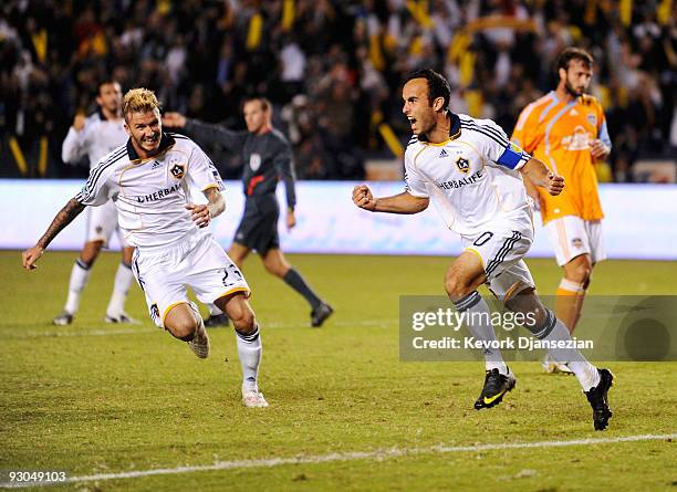 David Beckham and Landon Donovan of the Los Angeles Galaxy celebrate after Donovan's goal on a penalty kick against Houston Dynamo during the MLS...