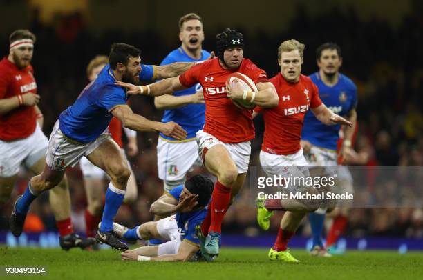 Leigh Halfpenny of Wales breaks away from Jayden Hayward of Italy during the NatWest Six Nations match between Wales and Italy at Principality...