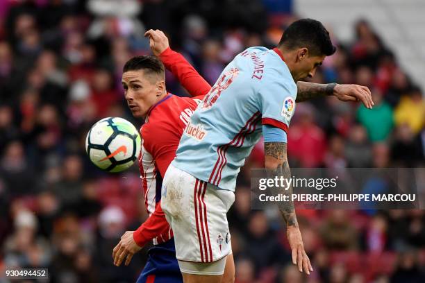 Atletico Madrid's Spanish forward Fernando Torres challenges Celta Vigo's Chilean midfielder Pedro Pablo Hernandez during the Spanish league football...