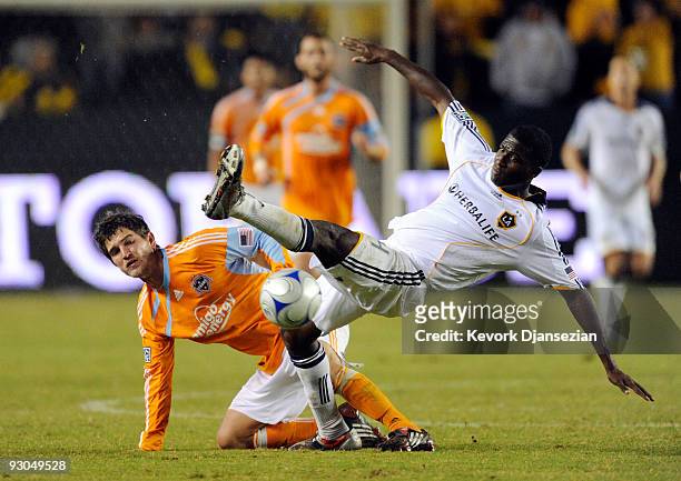 Edson Buddle of the Los Angeles Galaxy is tackled by Bobby Boswell of the Houston Dynamo during the MLS Western Conference Championship soccer match...