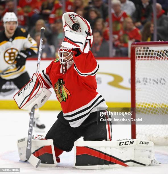 Anton Forsberg of the Chicago Blackhawks makes a glove save against the Boston Bruins at the United Center on March 11, 2018 in Chicago, Illinois.