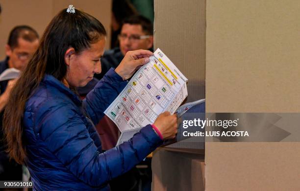 Woman votes at a polling station in Bogota, during parliamentary elections in Colombia on March 11, 2018. Colombians went to the polls Sunday to...