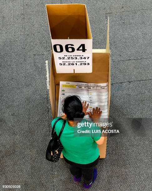 Woman votes at a polling station in Bogota, during parliamentary elections in Colombia on March 11, 2018. Colombians went to the polls Sunday to...