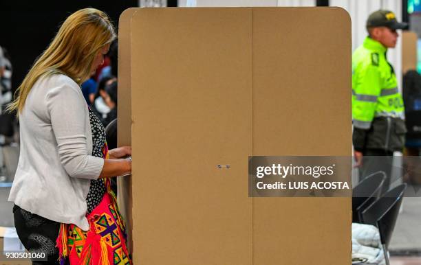 Woman votes at a polling station in Bogota, during parliamentary elections in Colombia on March 11, 2018. Colombians went to the polls Sunday to...