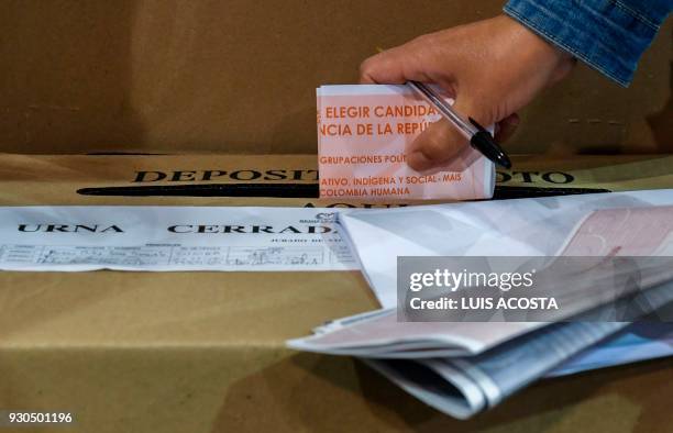 Person votes at a polling station in Bogota, during parliamentary elections in Colombia on March 11, 2018. Colombians went to the polls Sunday to...