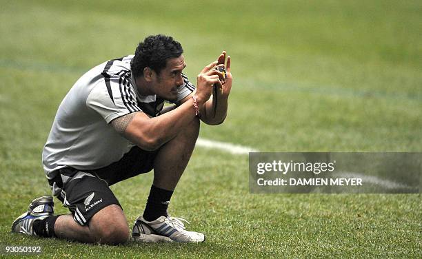 New Zealand's flanker Jerome Kaino takes pictures of the stadium during a training session at San Siro Stadium in Milan, on November 13, 2009 on the...