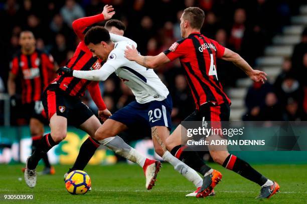 Tottenham Hotspur's English midfielder Dele Alli vies with Bournemouth's English midfielder Lewis Cook and Bournemouth's English midfielder Dan...