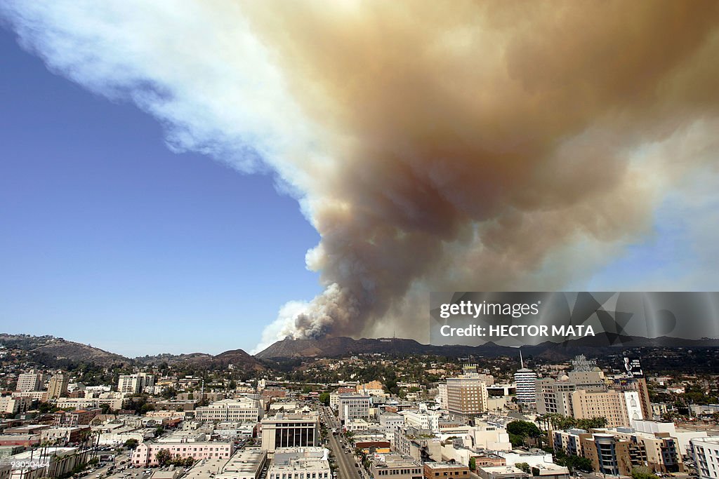 Smoke rises from a brush fire near the H