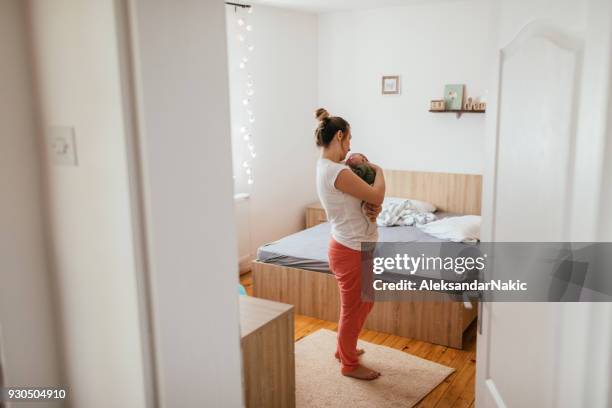 mother putting her baby to sleep - lullaby stock pictures, royalty-free photos & images