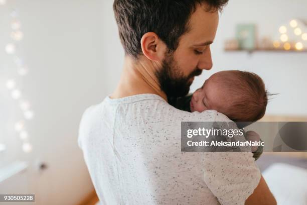 father putting his baby to sleep - dad baby stock pictures, royalty-free photos & images