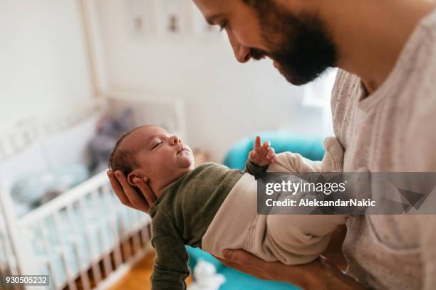 father putting his baby to sleep - lullaby stock pictures, royalty-free photos & images