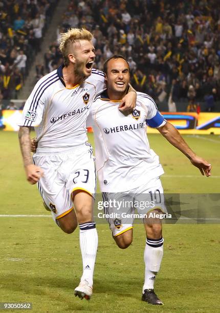 Landon Donovan of the Los Angeles Galaxy celebrates his goal scored against the Houston Dynamo with his teammate David Beckham during the 2009 MLS...