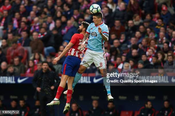 Diego Costa of Atletico Madrid competes for the ball with Pedro Pablo Hernandez of Celta de Vigo during the La Liga match between Atletico Madrid and...