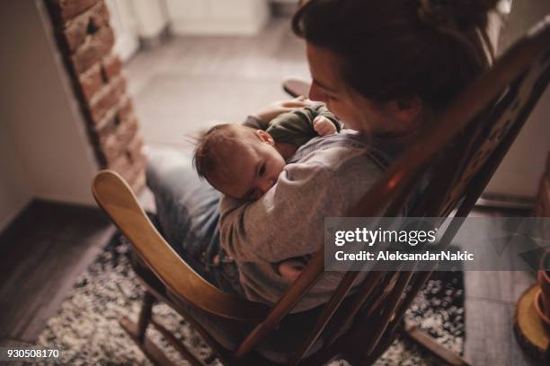 mommy and baby in a rocking chair - rocking chair stock pictures, royalty-free photos & images