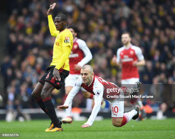 Jack Wilshere of Arsenal challenged by Abdoulaye Doucoure of Watford during the Premier League match between Arsenal and Watford at Emirates Stadium...