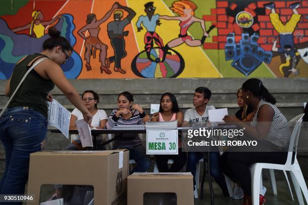 Woman casts her vote at a polling station in Cali, Valle del Cauca Department, during parliamentary elections in Colombia on March 11, 2018....