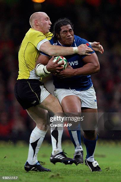 Wales' Tom Shanklin tackles Samoa's Henry Tuilagi high during the international rugby match at Millennium Stadium, on November 13, 2009 . AFP...