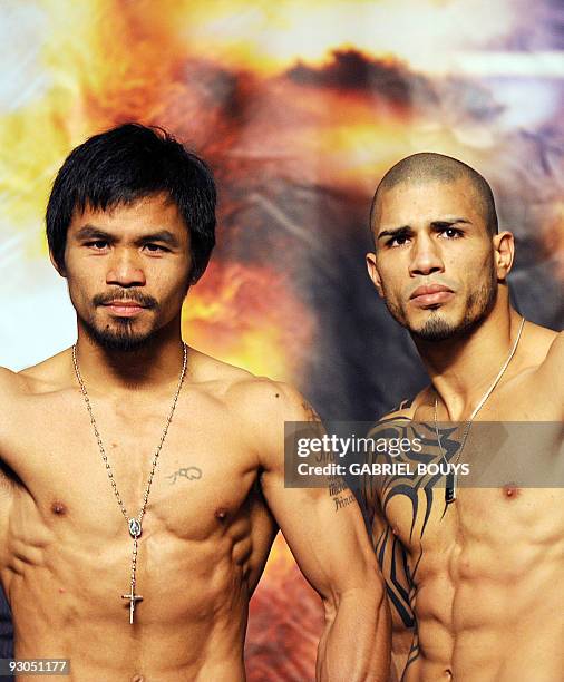 Champion Miguel Cotto of Puerto Rico poses during the official weigh-in for his fight against Welterweight boxing champion Manny "PacMan" Pacquiao of...