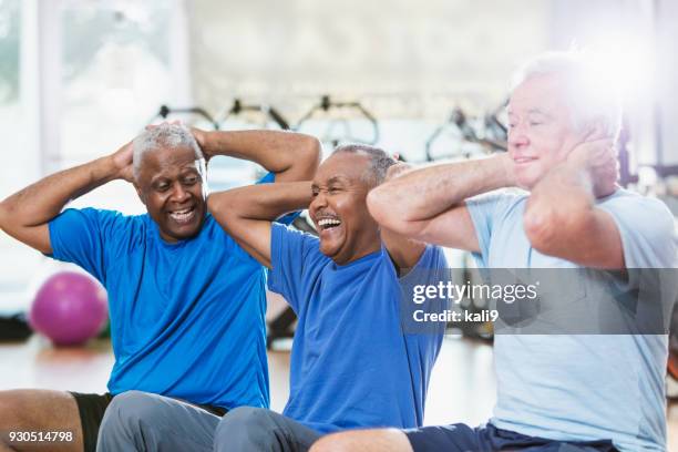 three multi-ethnic senior men in gym exercising - gym excercise ball stock pictures, royalty-free photos & images