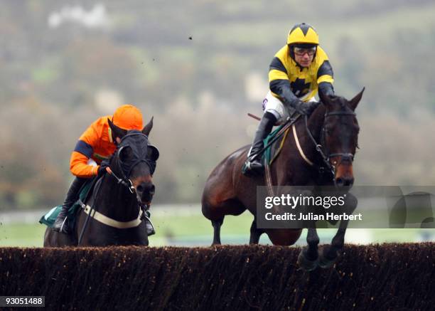 Paddy Brennan and Pettifour leat the Aidan Coleman ridden Toby Jug over a fence on route to wining The Ultima Frontrunner In IT Solutions Novices'...