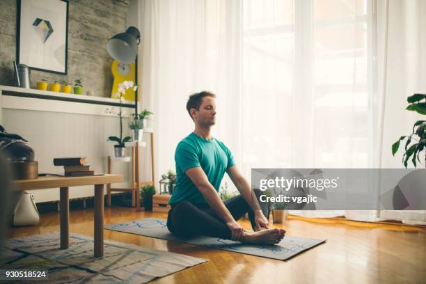 yoga at home - wellbeing man stock pictures, royalty-free photos & images