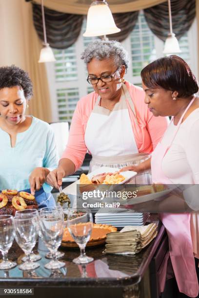 african-american women serving home cooked meal - american pie reunion stock pictures, royalty-free photos & images