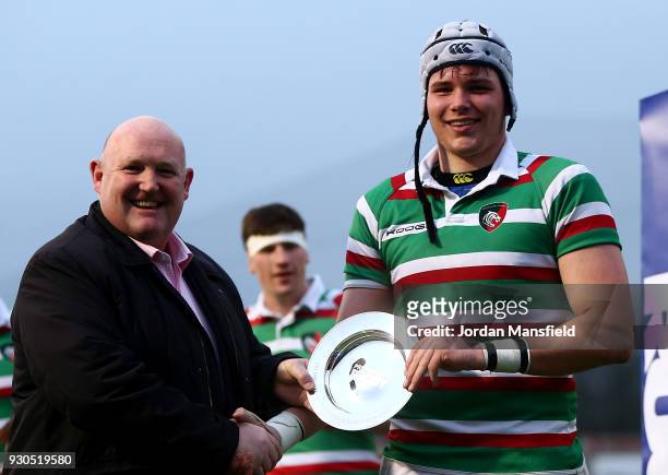 The of Leicester Tigers U18 captain poses with the trophy after the Premiership Rugby U18s Academy Final between Leicester Tigers U18 and Gloucester...