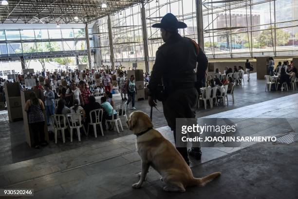 People vote at a polling station in Medellin, Antioquia Department, during parliamentary elections in Colombia on March 11, 2018. Colombians went to...