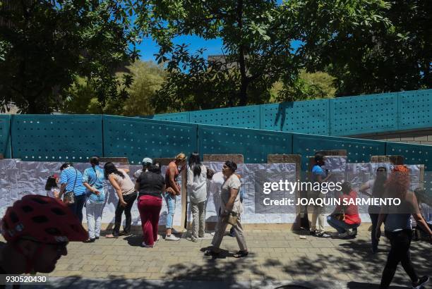 People check the electoral roll at a polling station in Medellin, Antioquia Department, during parliamentary elections in Colombia on March 11, 2018....