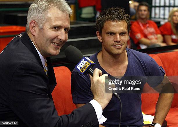 Fox presenter Andrew Gaze talks with Byron Schammer of the Fremantle Dockers Football Club during the round eight NBL match between the Perth...