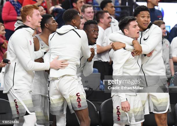 Players on the Arizona Wildcats bench react after a dunk by teammate Rawle Alkins against the USC Trojans in the second half of the championship game...