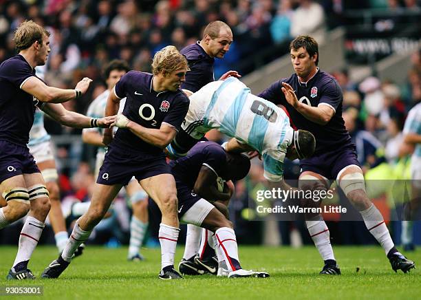 Juan Martin Fernandez Lobbe of Argentina goes over the top of Ugo Monye of England during the Investec Challenge match between England and Argentina...