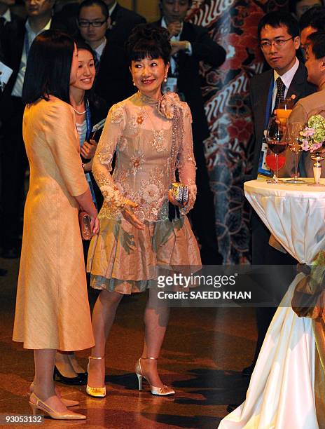 Japanese Prime Minister Yukio Hatoyama's wife talks with wife of Thailand's Prime Minister Abhisit Vejjajiva at a reception prior to dinner during...