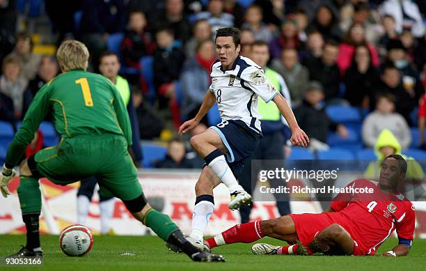 Don Cowie of Scotland is tackled by Ashley Williams of Wales during the International Friendly match between Wales and Scotland at the Cardiff City...