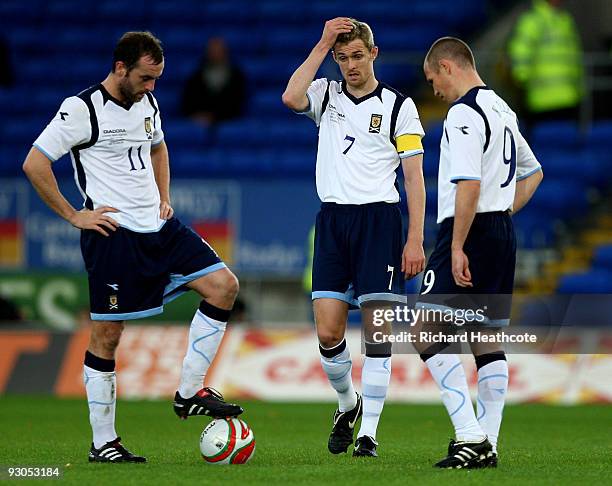 James McFadden, Darren Fletcher and Kenny Miller of Scotland look dejected after Wales score the third goal during the International Friendly match...