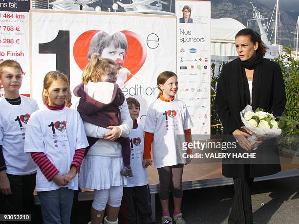 Princess Stephanie of Monaco holds flowers near children on November 14, 2009 in Monaco prior to give the start of the No Finish Line pedestrian...