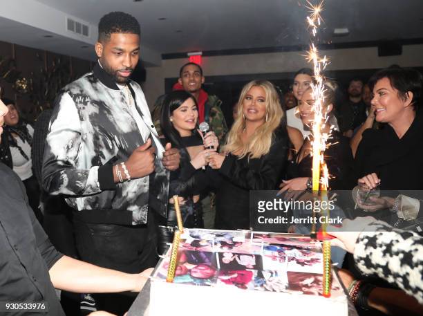 Tristan Thompson blows out his birthday candles as Khloe Kardashian, Kylie Jenner, Kris Jenner and friends look on at Remy Martin Presents Tristan...